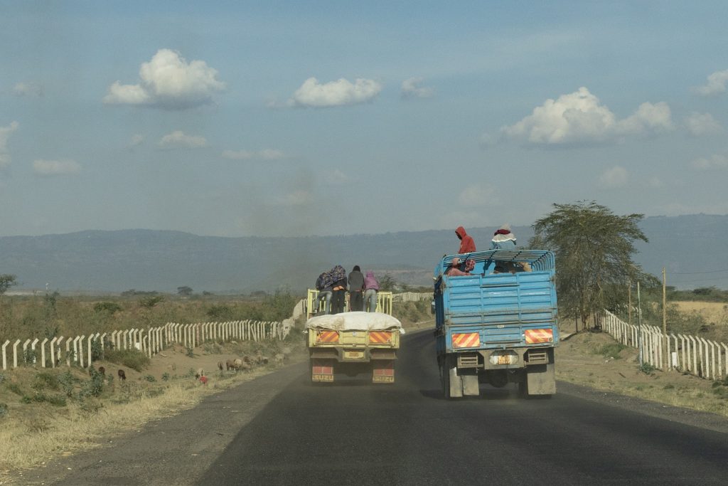 Überholender blauer LKW auf einer Überlandstraße in Kenia