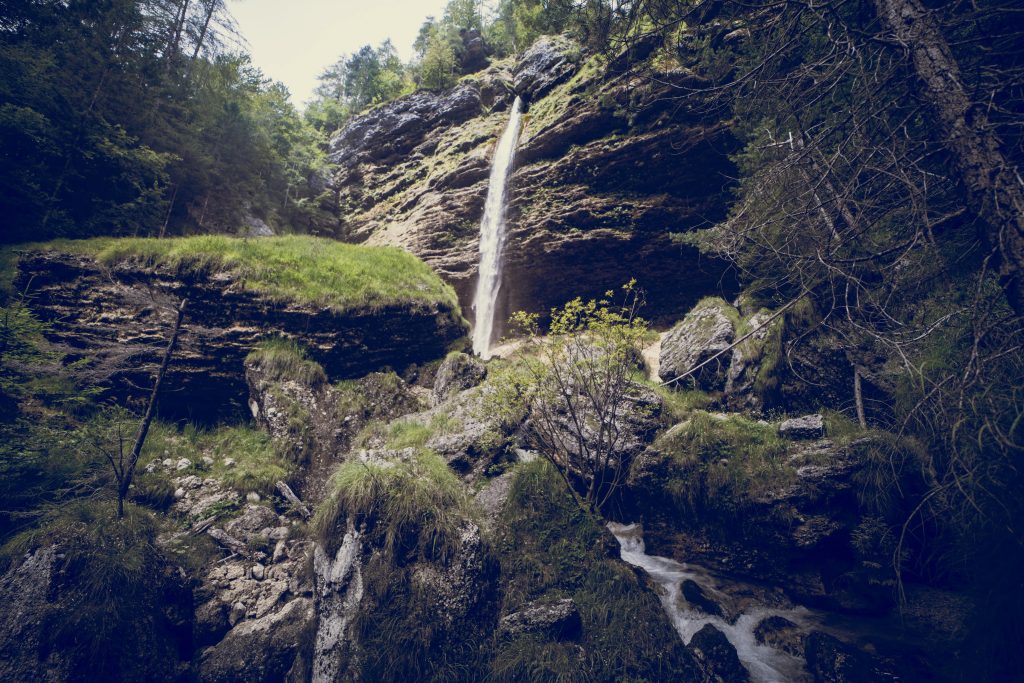 Blick auf den Slap Pericnik im Grünen, rundherum viel Moos und Bäume